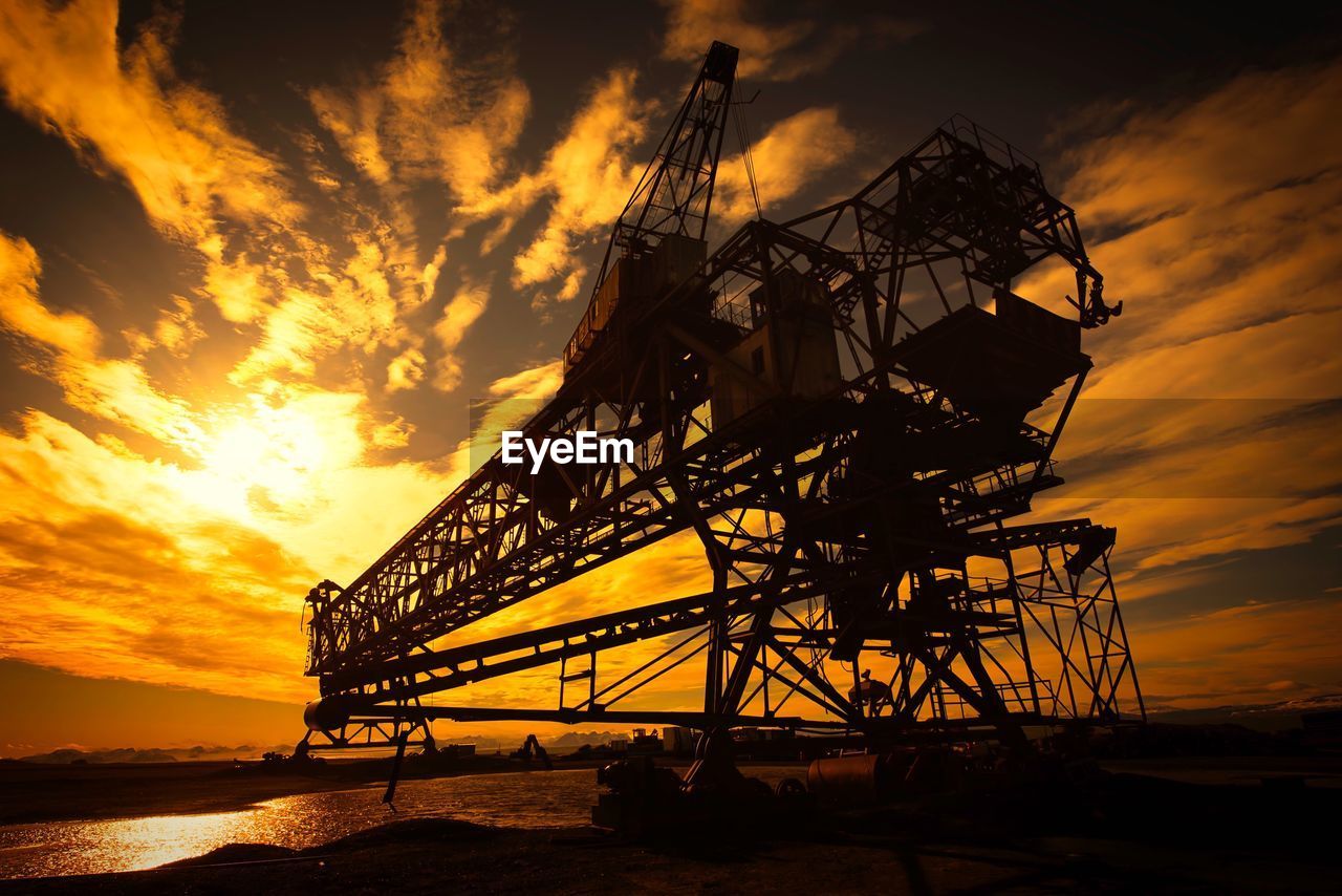 Low angle view of silhouette bridge against sky during sunset