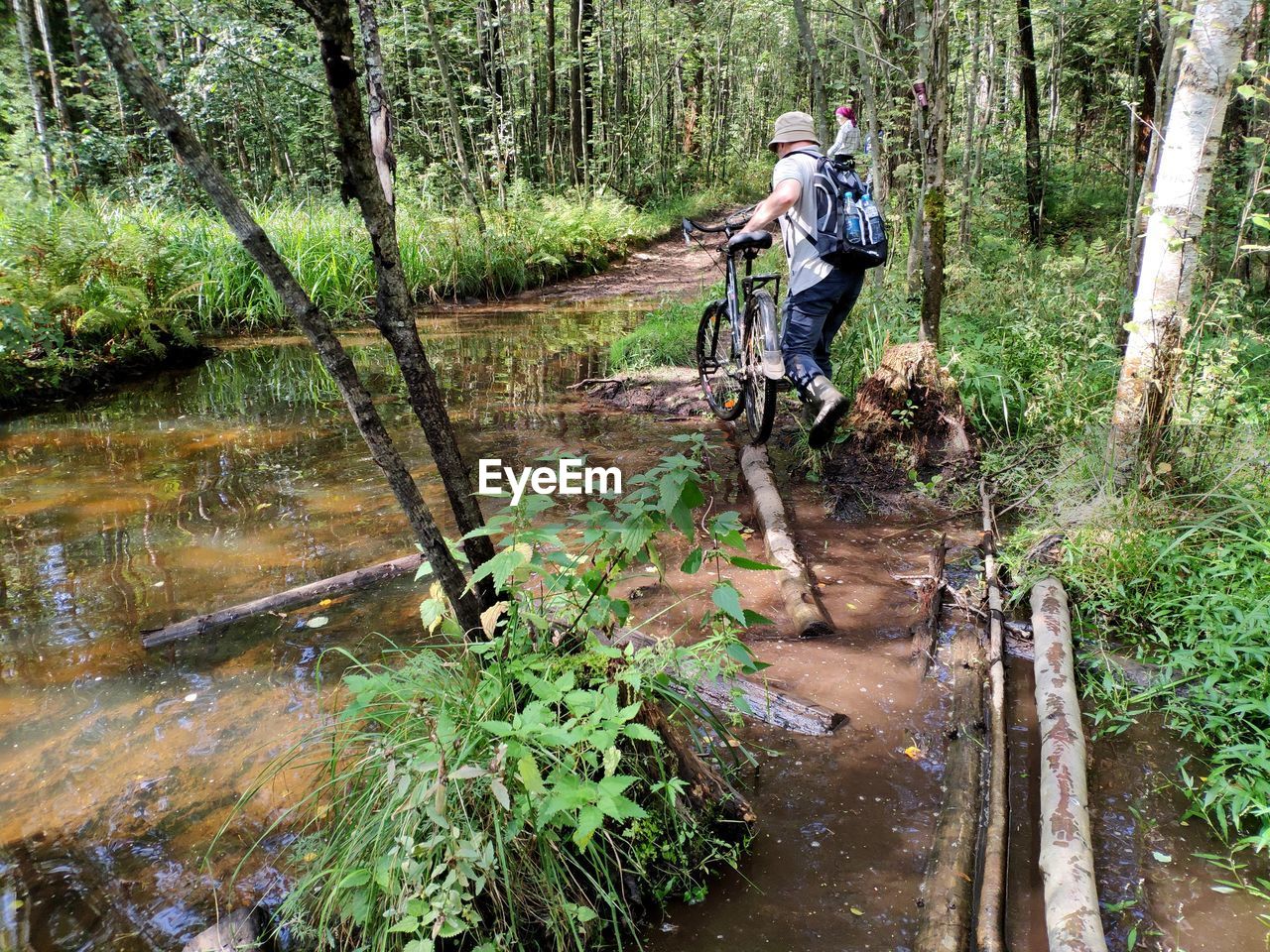 PERSON BY STREAM IN FOREST