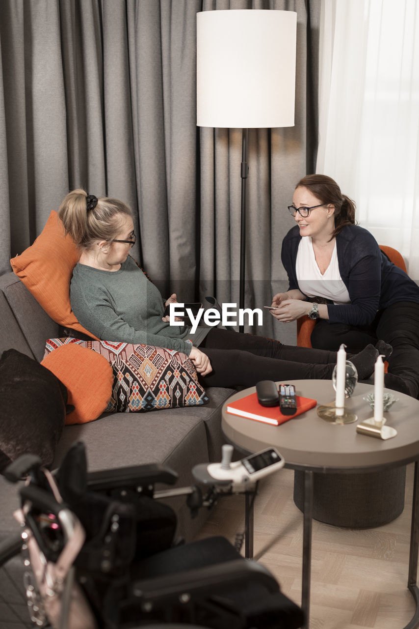 Female friends sitting in living room