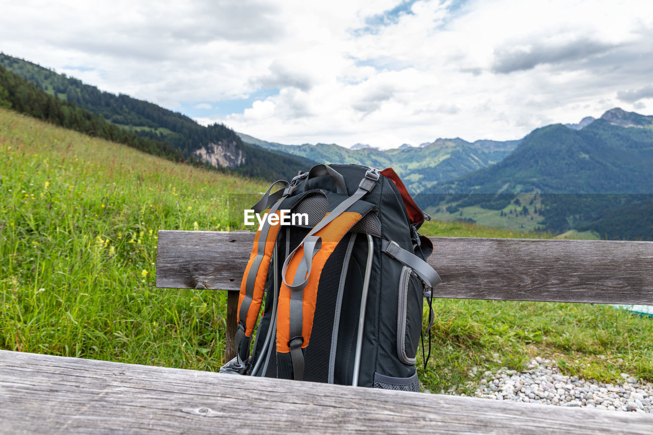 BUILT STRUCTURE ON FIELD AGAINST MOUNTAIN RANGE