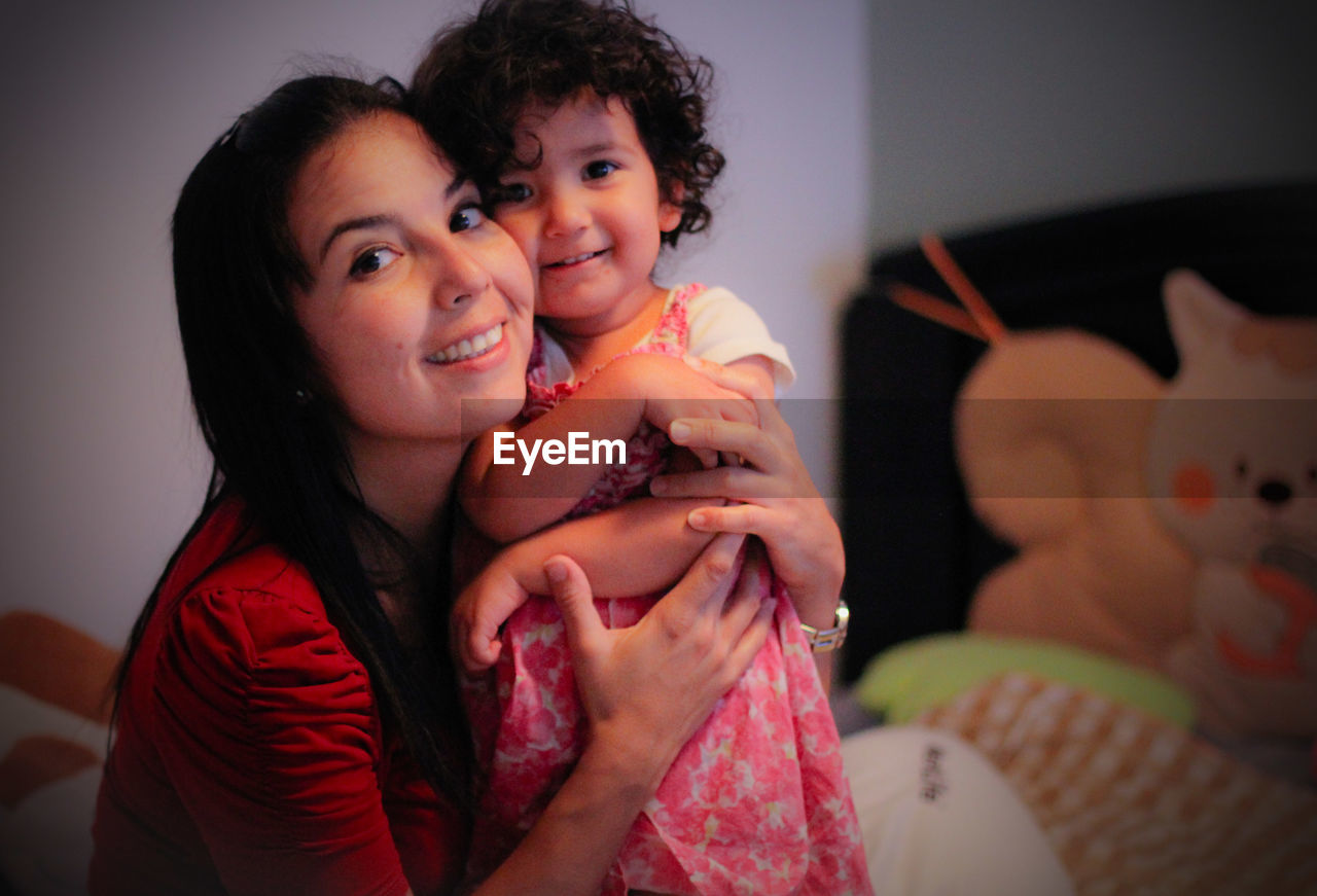 Portrait of smiling young woman with daughter