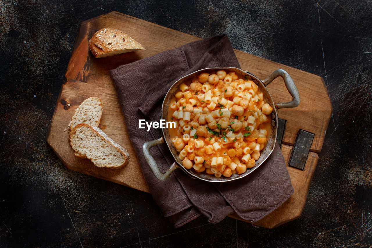 Directly above shot of pasta in container over cutting board