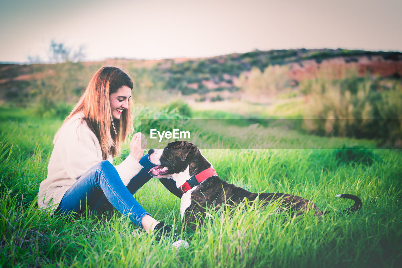 Woman with dog on field