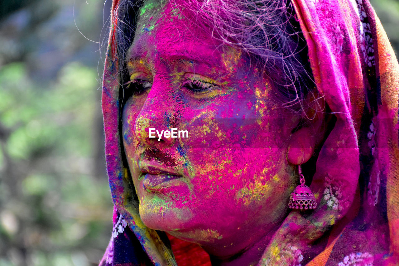 holi, multi colored, celebration, portrait, tradition, one person, women, traditional festival, adult, human face, headshot, paint, religion, face paint, lifestyles, human head, pink, event, close-up, young adult, powder paint, face powder, focus on foreground, child, female, belief, make-up, childhood, body paint, emotion, day, outdoors, human eye, temple, vibrant color, red, dirt, traditional clothing, smiling, leisure activity, life events, happiness, purple, arts culture and entertainment