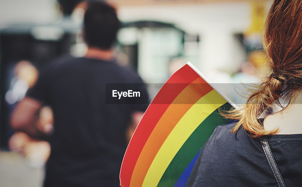 Rear view of woman with rainbow flag