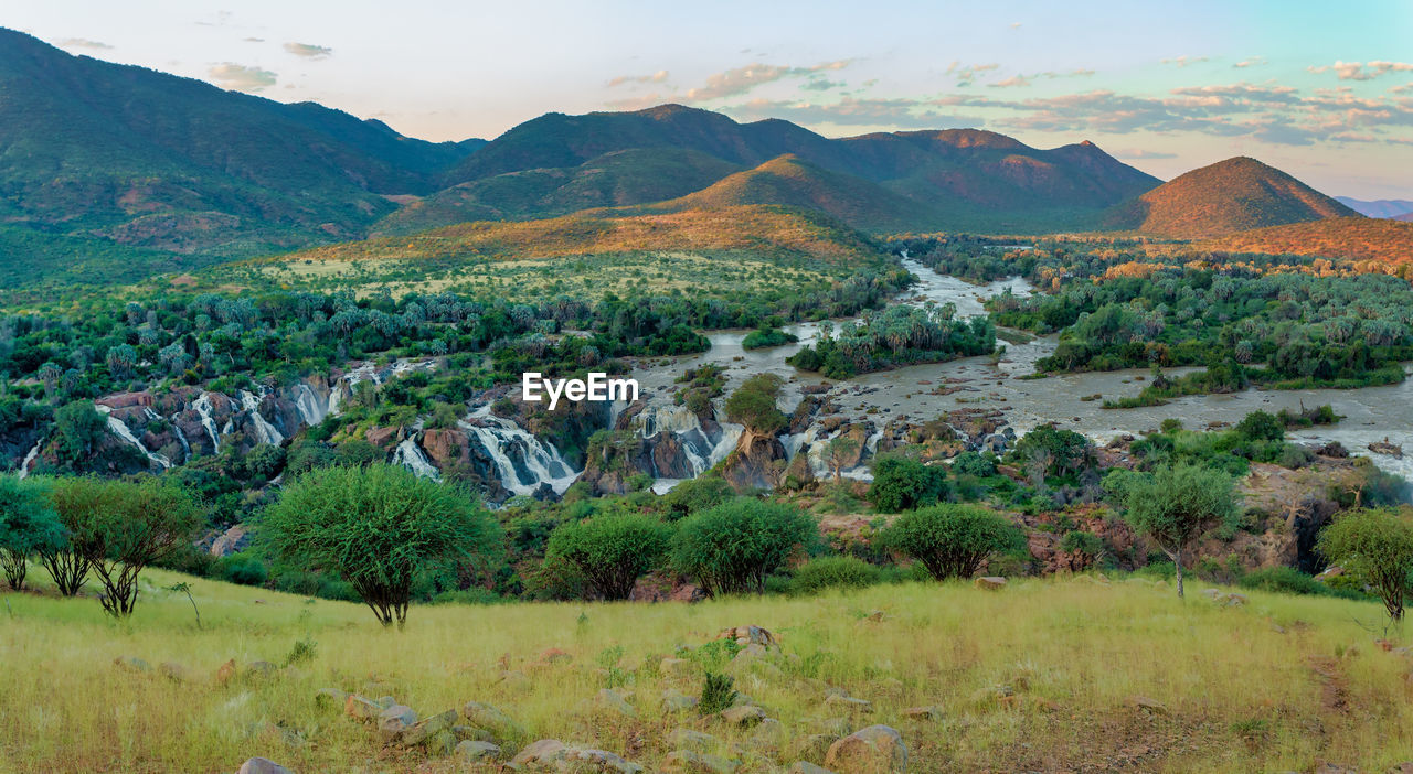 Scenic view of landscape and mountains against sky