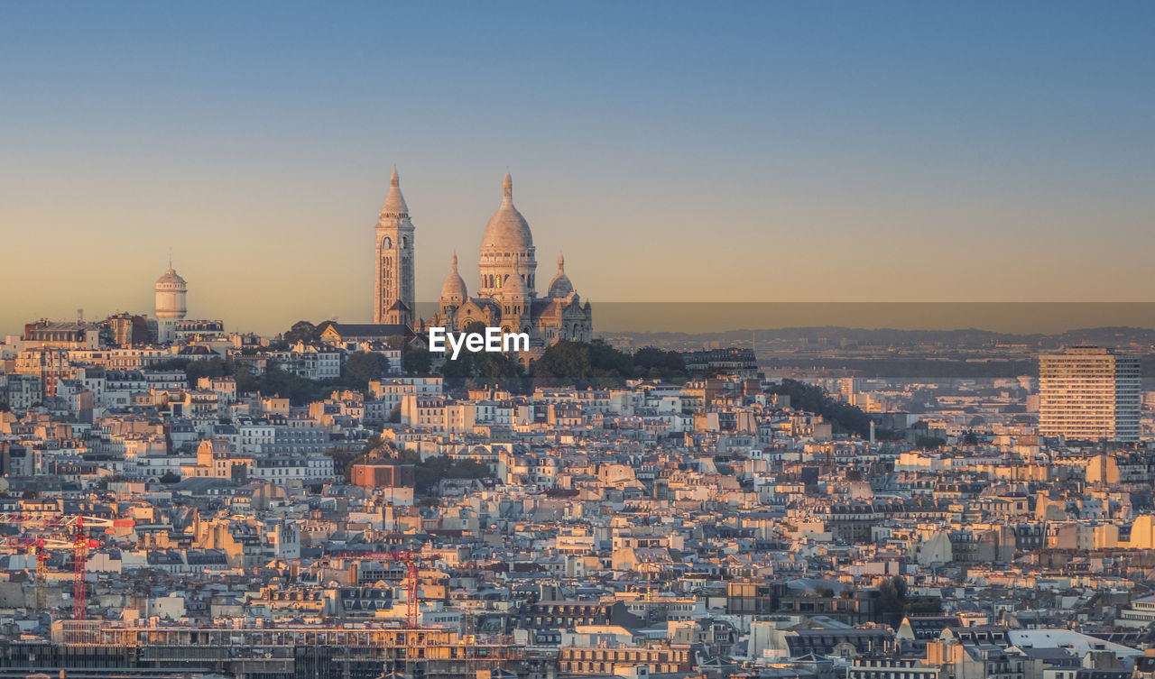 Aerial view of paris with montmartre in background at sunset