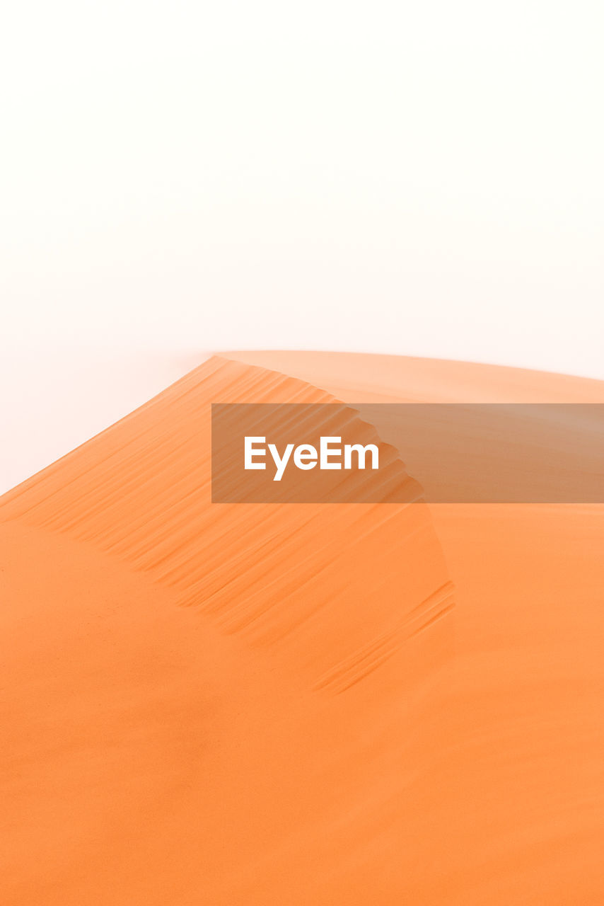 Minimal shapes of the desert's sand. a scenic view of desert against clear sky