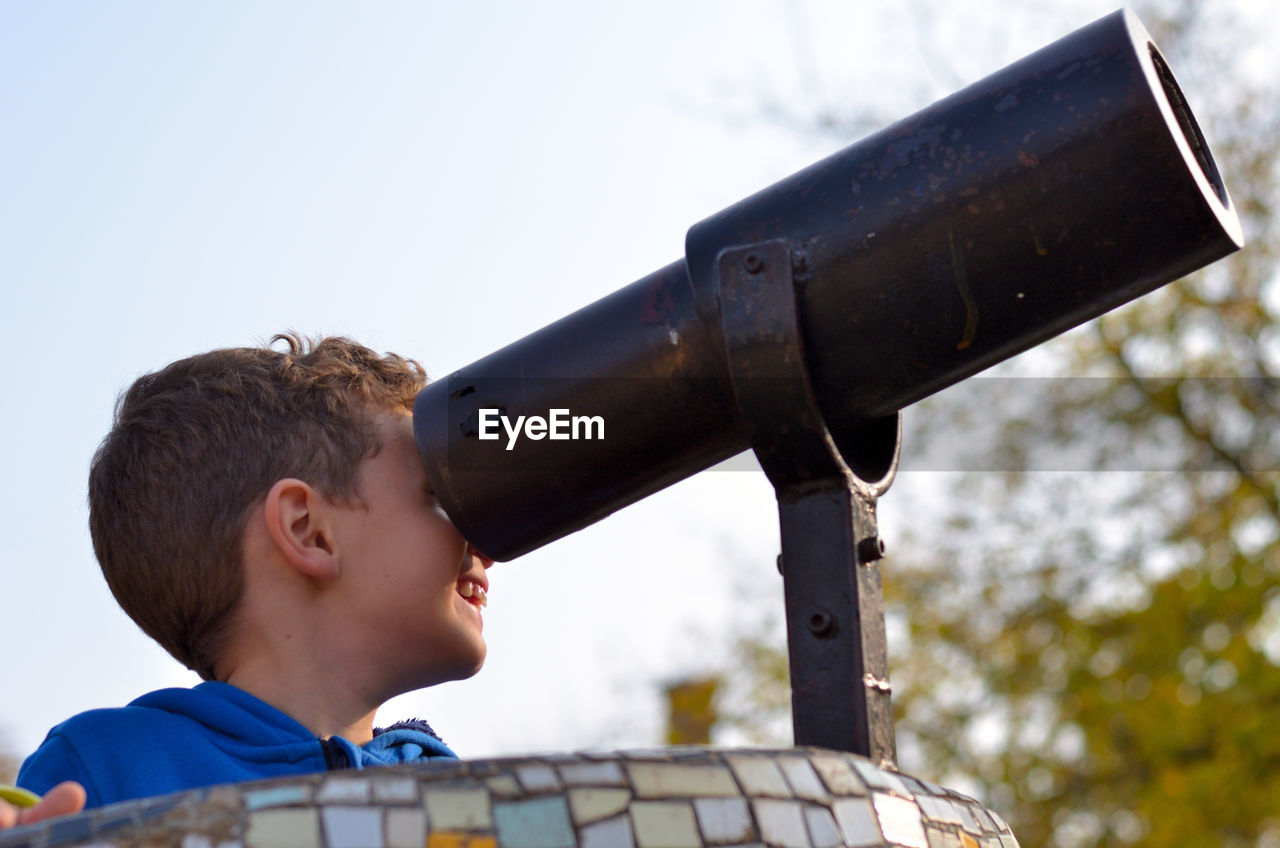 Boy looking through telescope