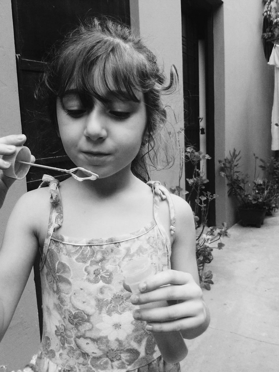 PORTRAIT OF CUTE GIRL HOLDING WHITE WALL