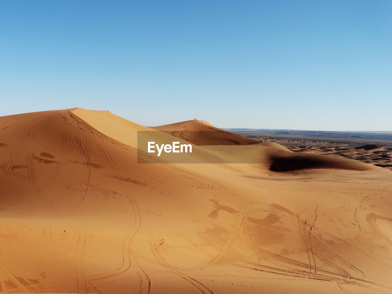 Sand dunes against blue sky