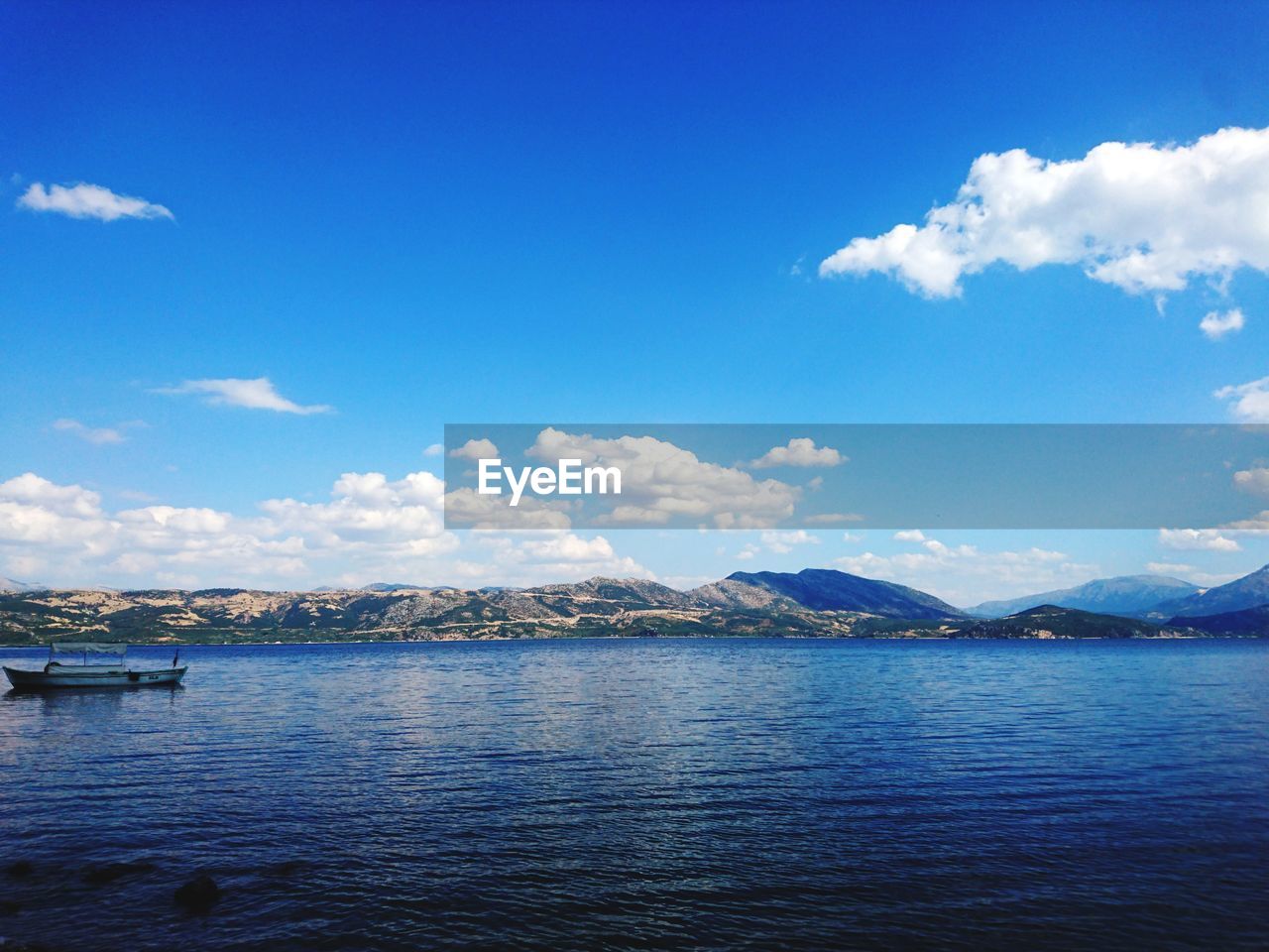 Scenic view of sea against blue sky