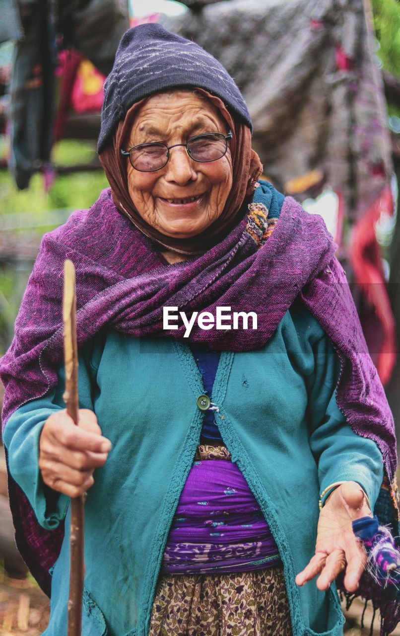 Portrait of smiling woman standing outdoors