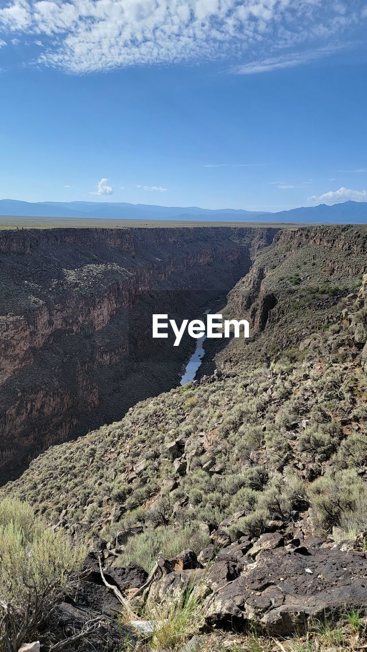 SCENIC VIEW OF LANDSCAPE AND MOUNTAINS AGAINST SKY