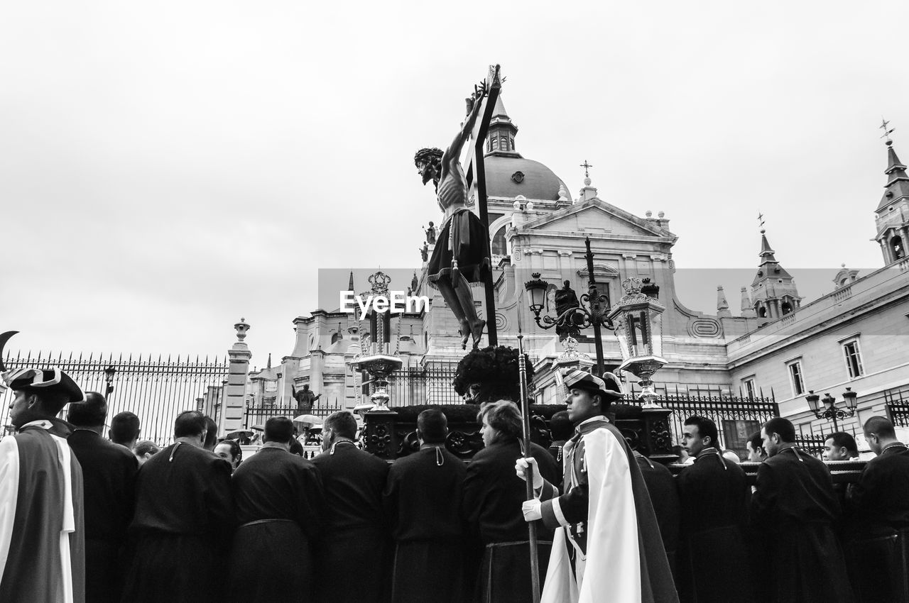 LOW ANGLE VIEW OF PEOPLE AGAINST SKY