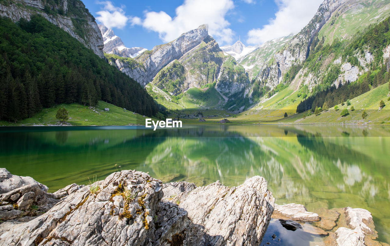 Scenic view of lake and mountains against sky