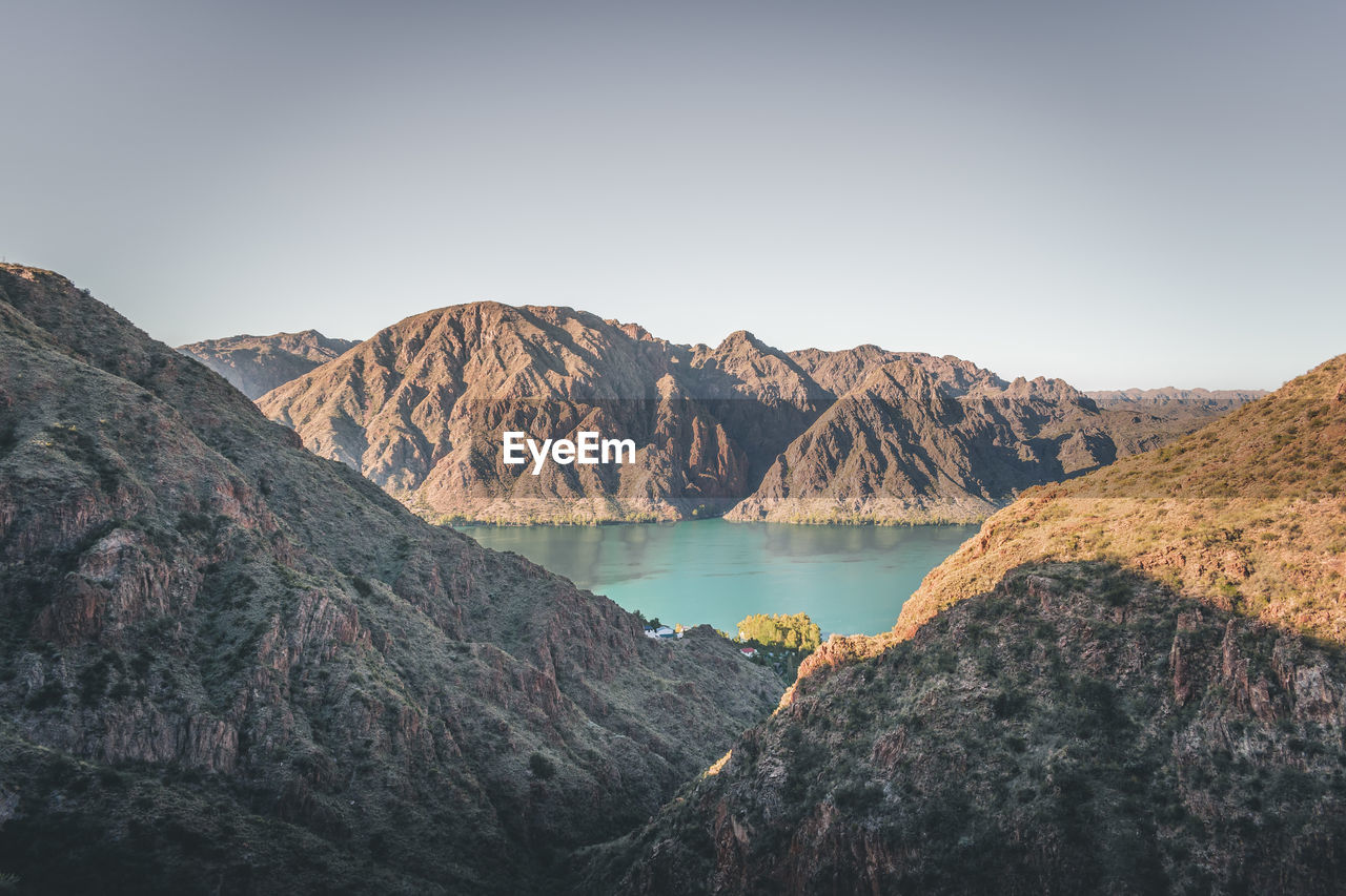 Scenic view of lake and mountains against clear sky