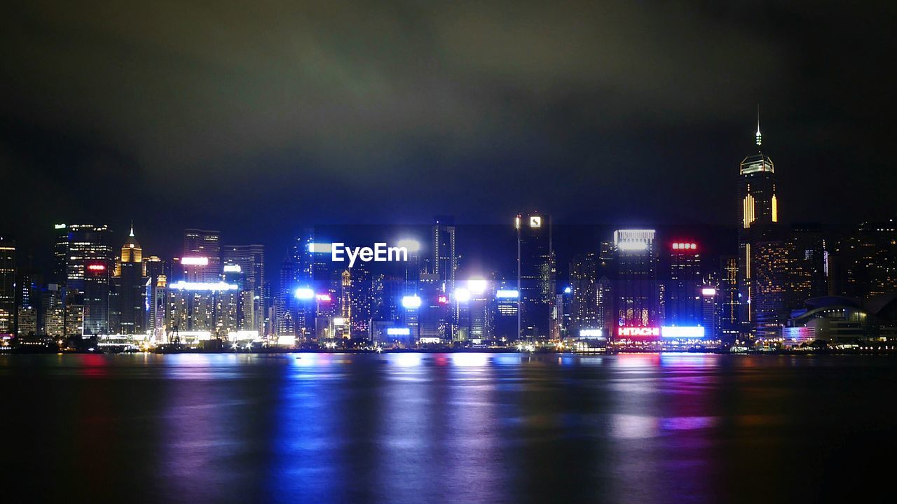 City lit up at night at waterfront