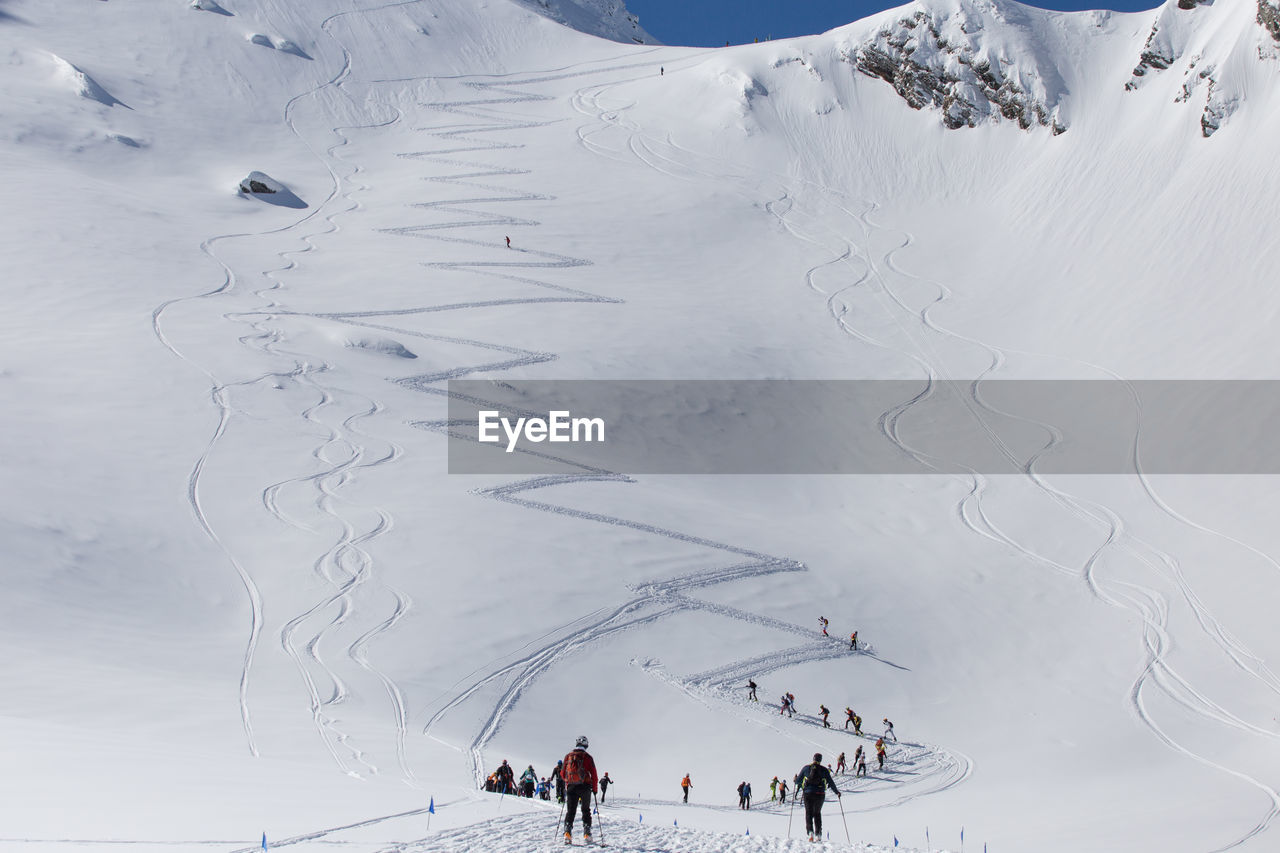 High angle view of people on snow covered mountain