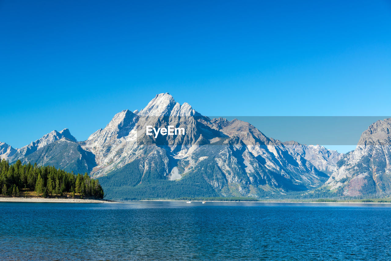 Scenic view of lake with mountain range in background