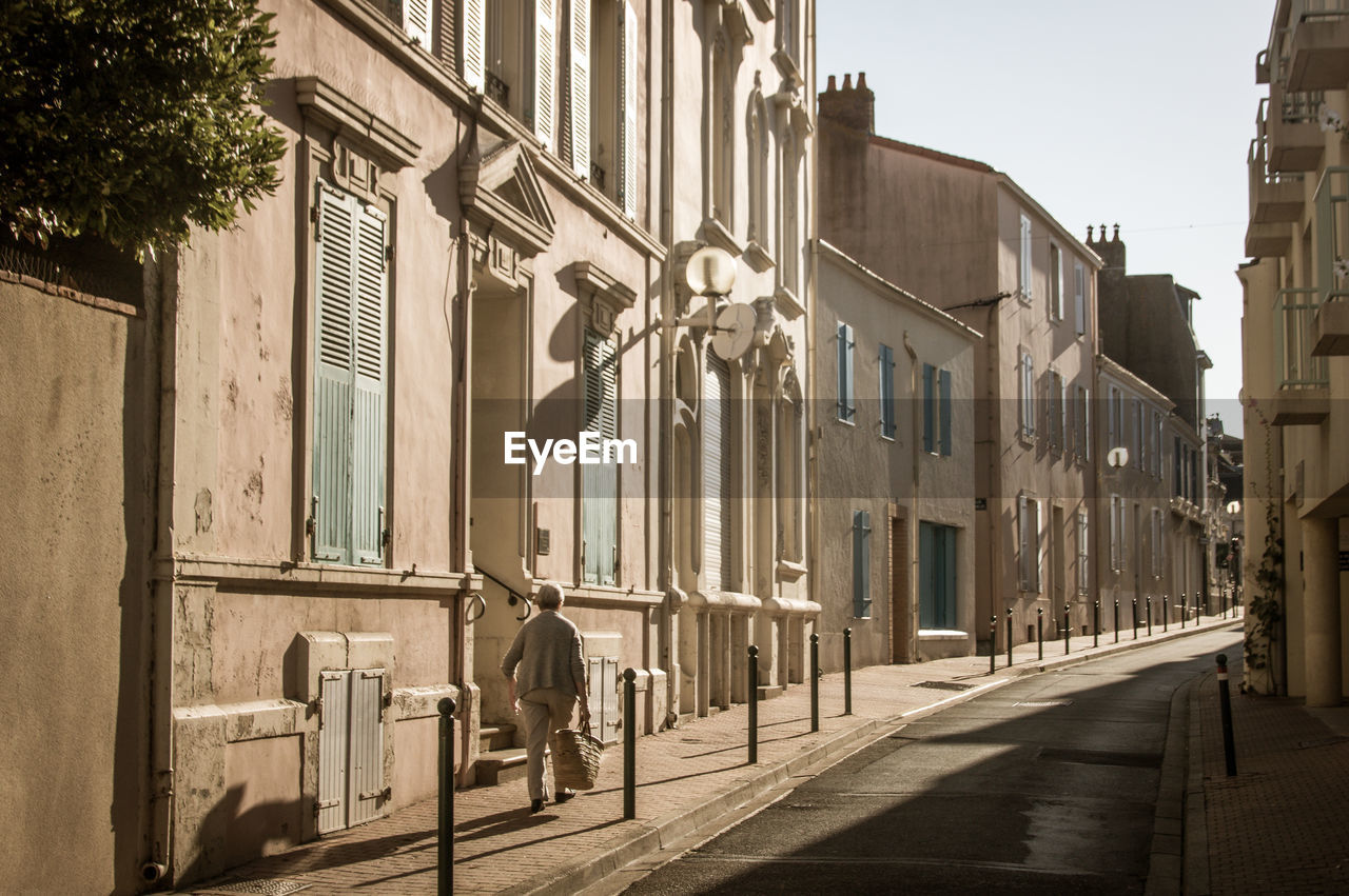 A street in les sables d'olonne with a lady walking in the morning light