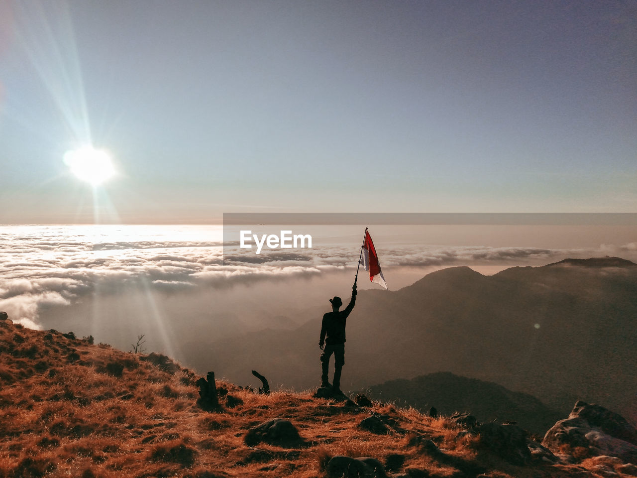 Rear view of person standing in sea against sky