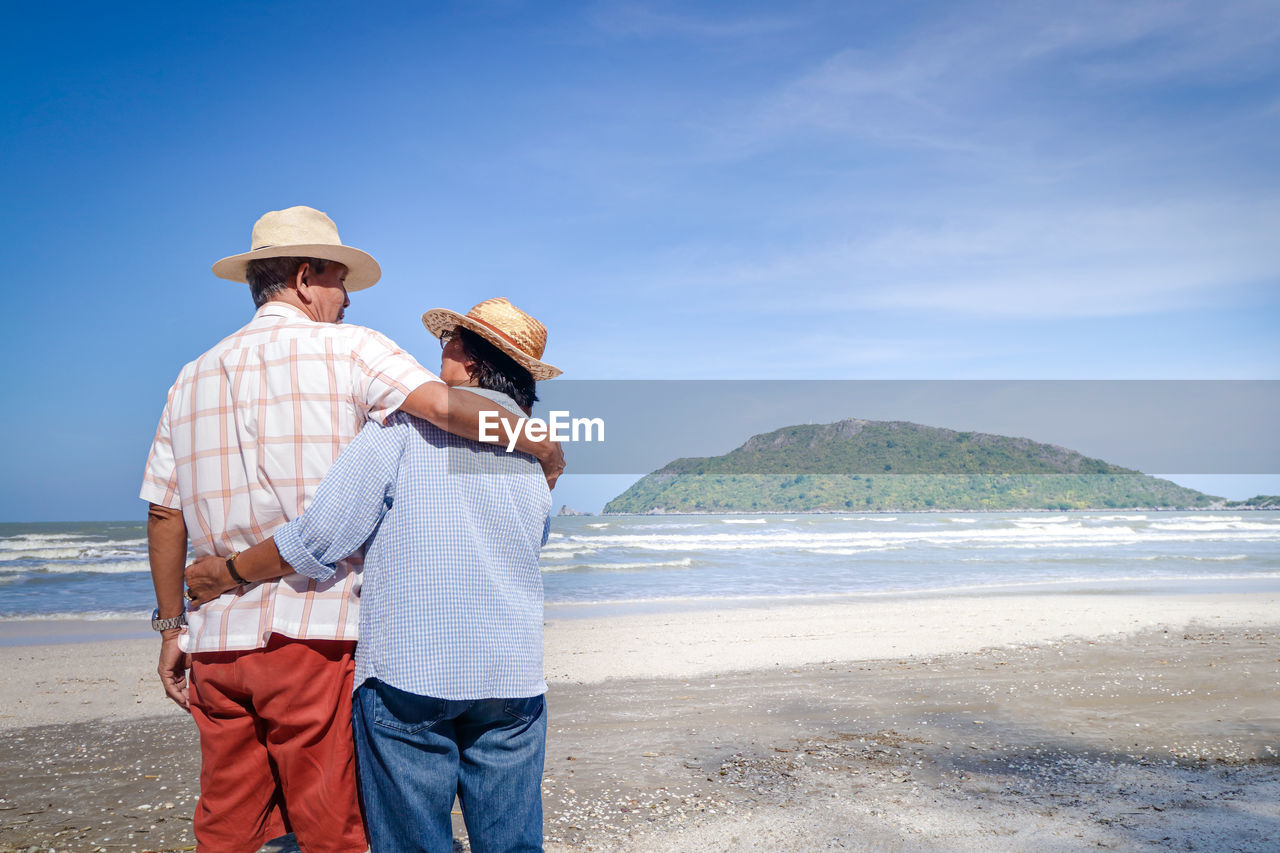 MAN STANDING ON BEACH