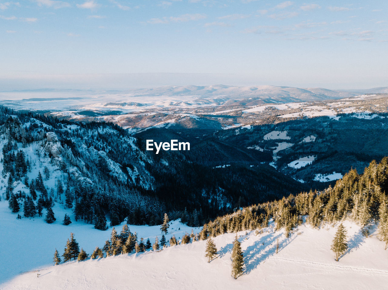 Scenic view of snowcapped mountains against sky during winter