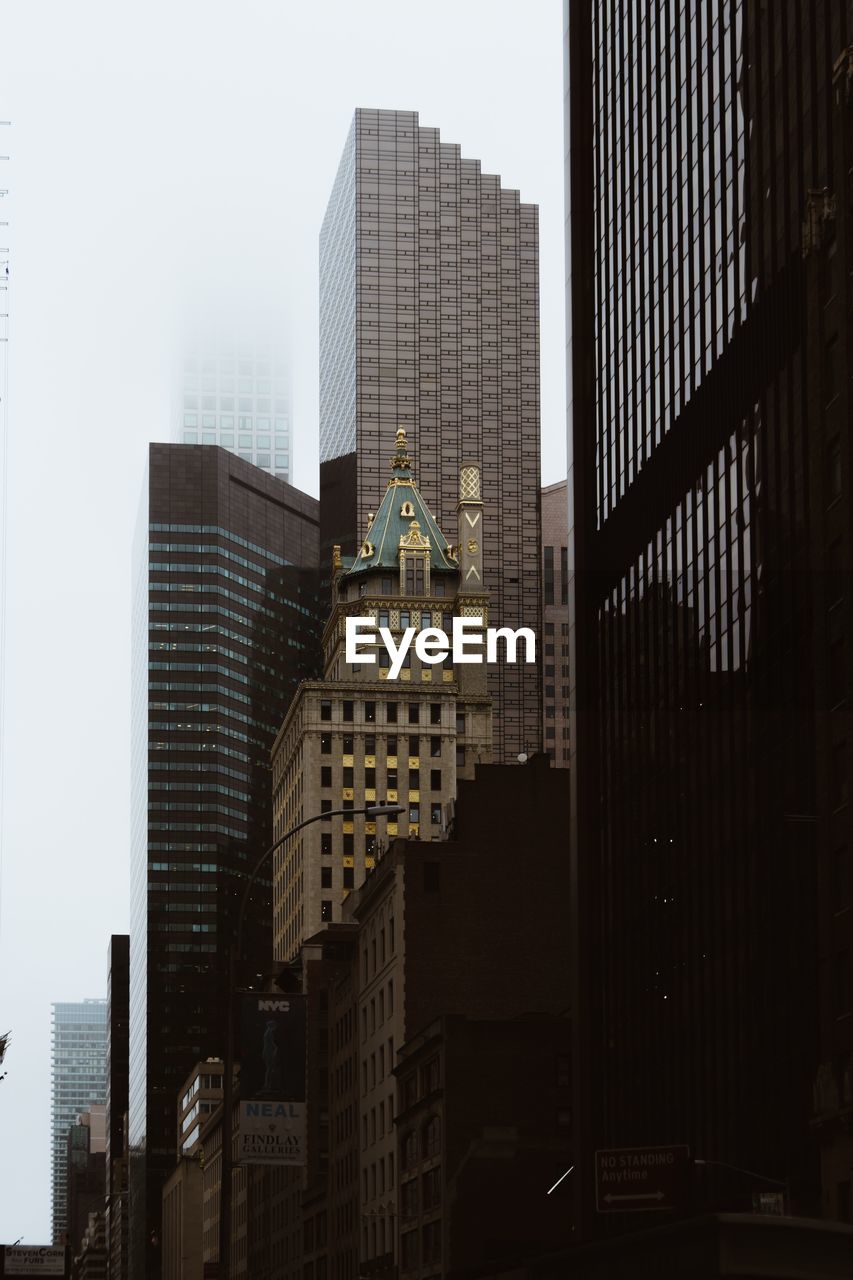 Low angle view of buildings in city against sky