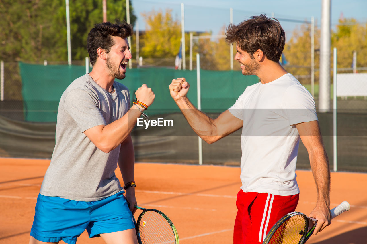 Friends on tennis court