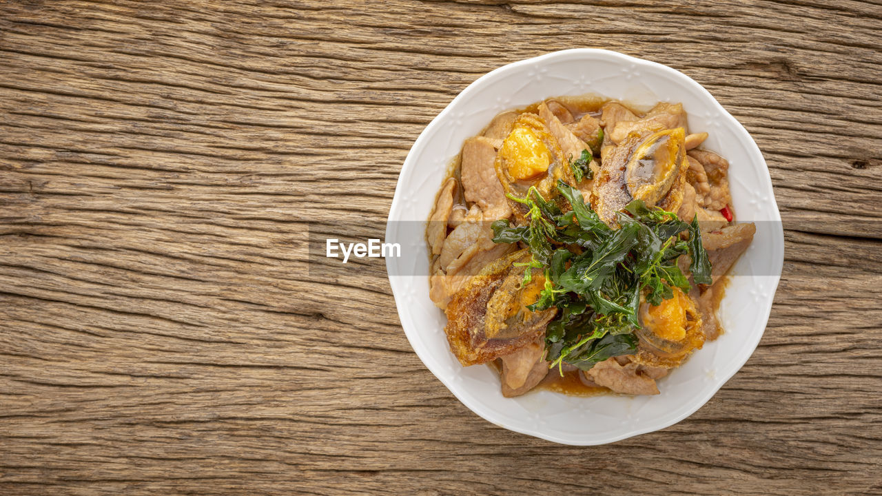 Pad ka prao kai yeow ma, basil stir fried century egg and sliced pork with crispy basil leaves