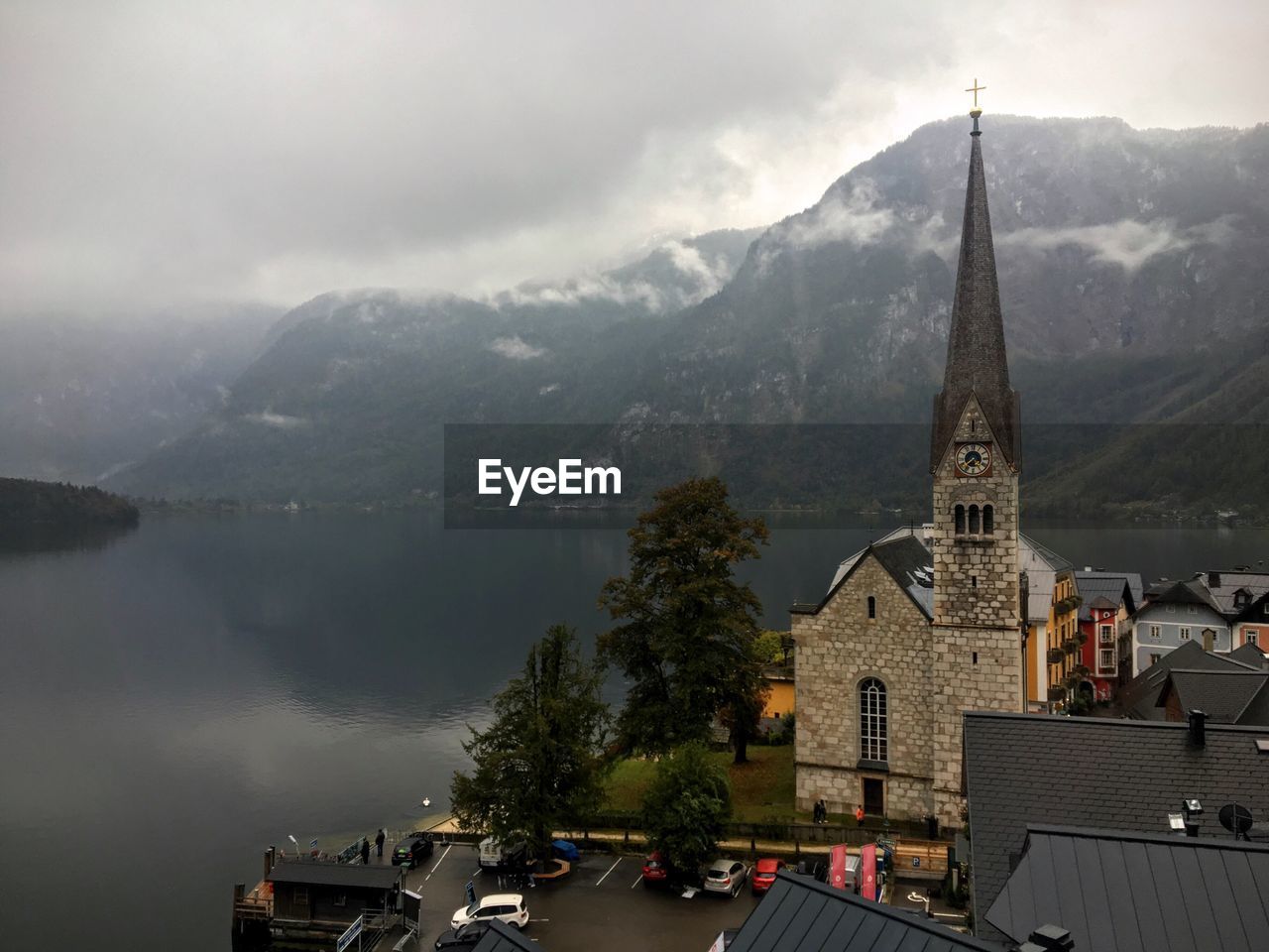 Church by lake against mountain