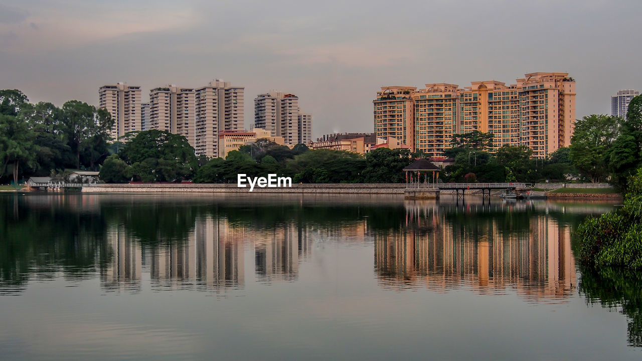 Reflection of buildings in lake against sky