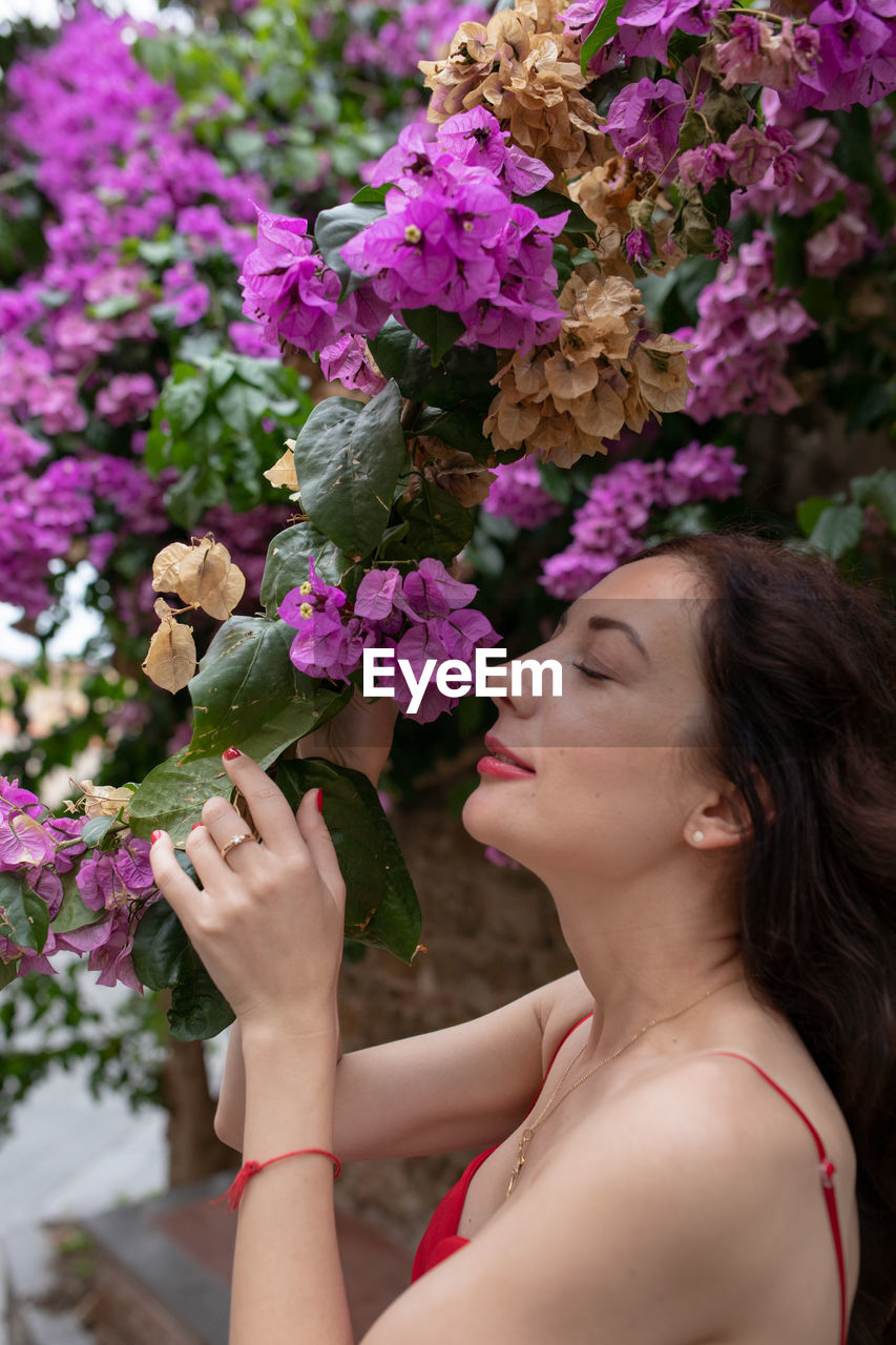 Woman smelling purple flowers