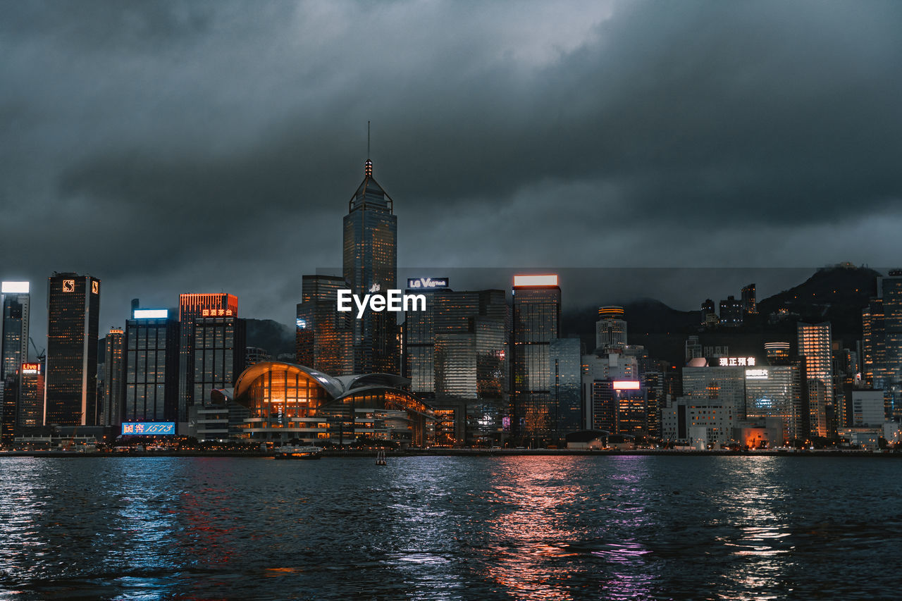 ILLUMINATED BUILDINGS AGAINST CLOUDY SKY