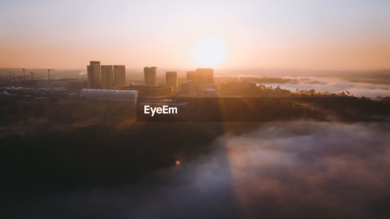 Drone flight above a valley in luxembourg-city suring sunrise. the financial centre and the cjeu of 