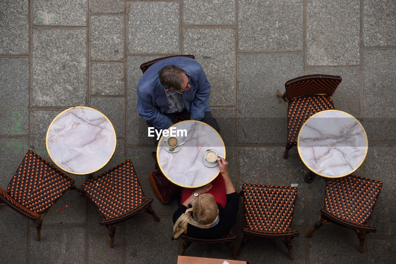 People sitting at sidewalk cafe