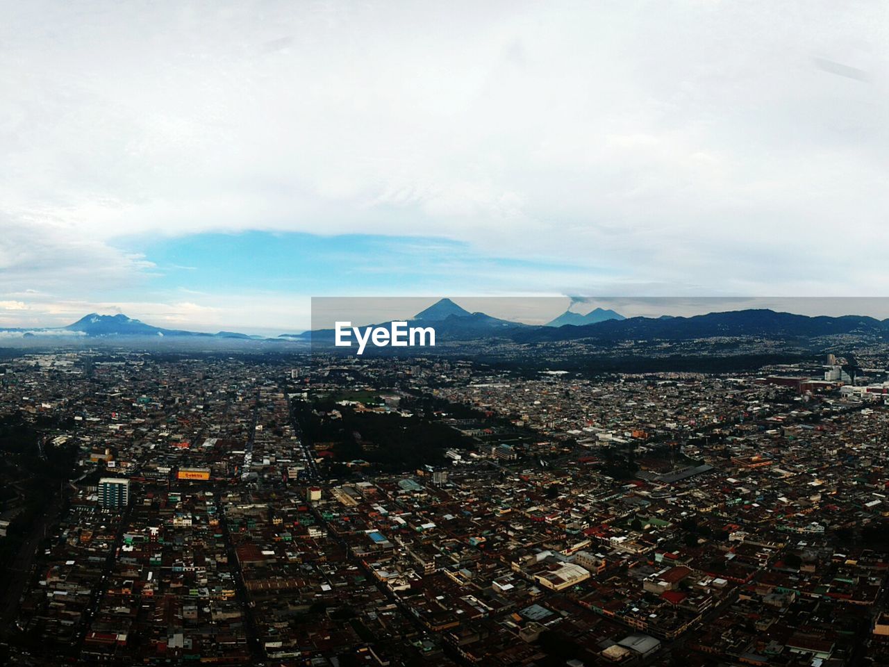 HIGH ANGLE VIEW OF ILLUMINATED CITY AGAINST SKY