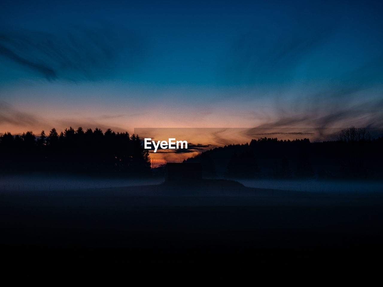 Scenic view of silhouette landscape against sky at sunset