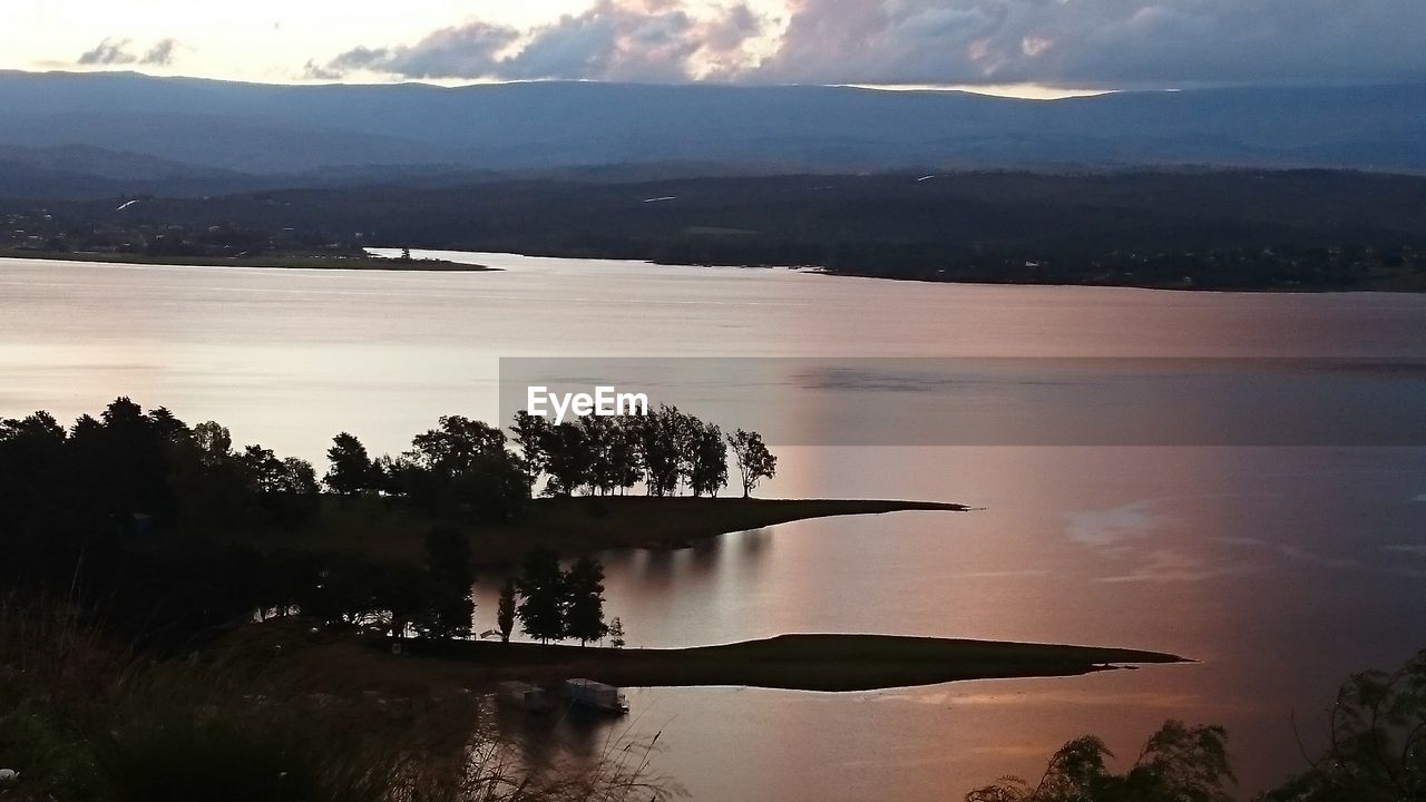 SCENIC VIEW OF LAKE BY SILHOUETTE TREES AGAINST SKY