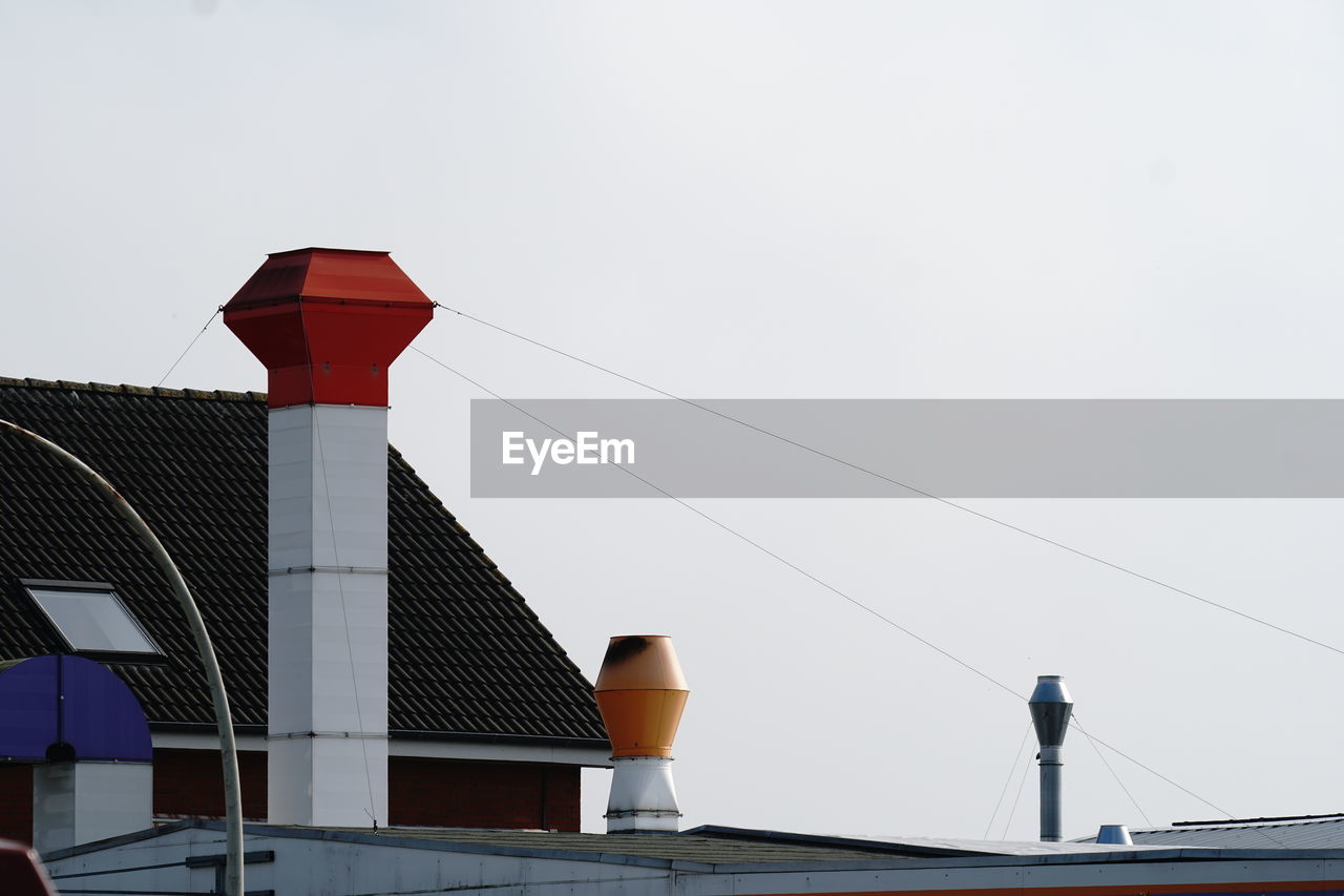 LOW ANGLE VIEW OF INDUSTRY AGAINST CLEAR SKY