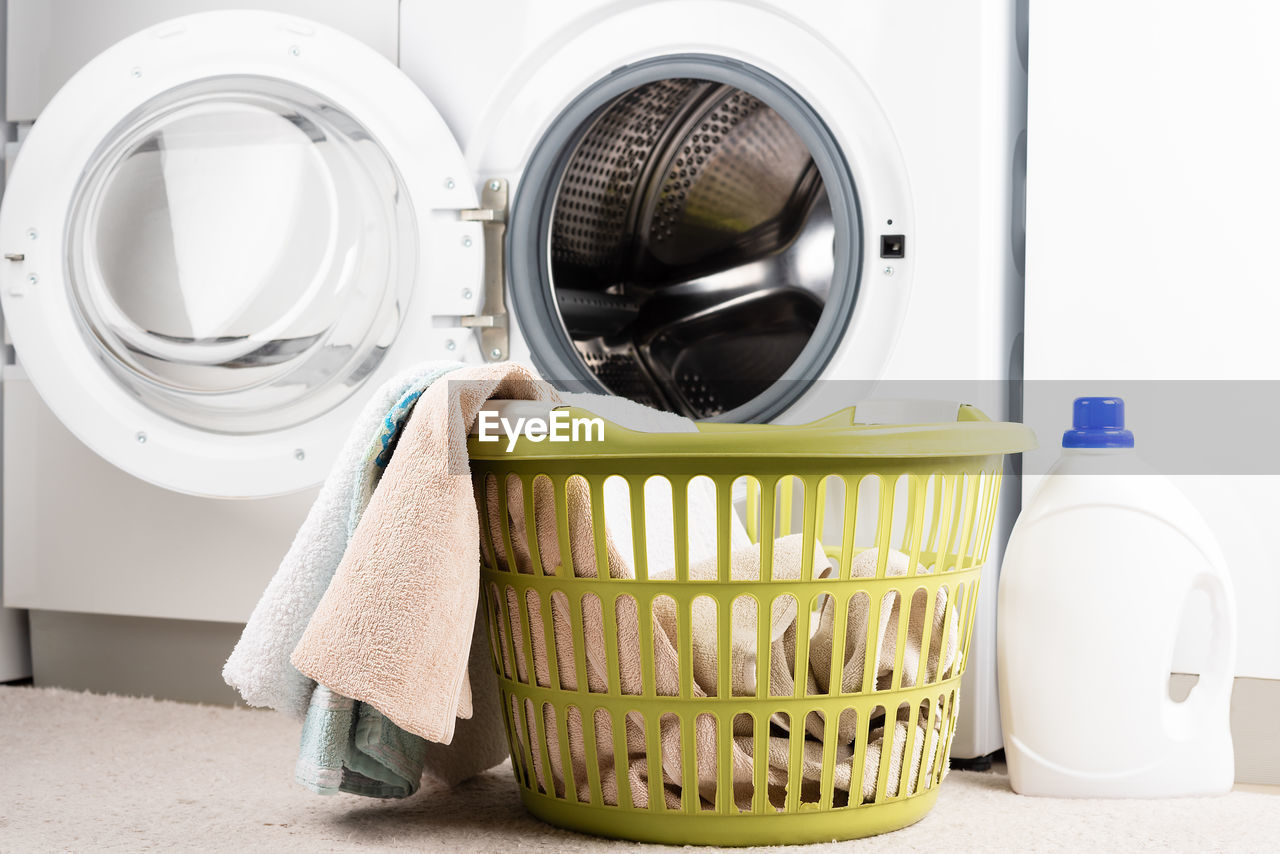 Laundry basket, liquid detergent and washing machine. place to insert