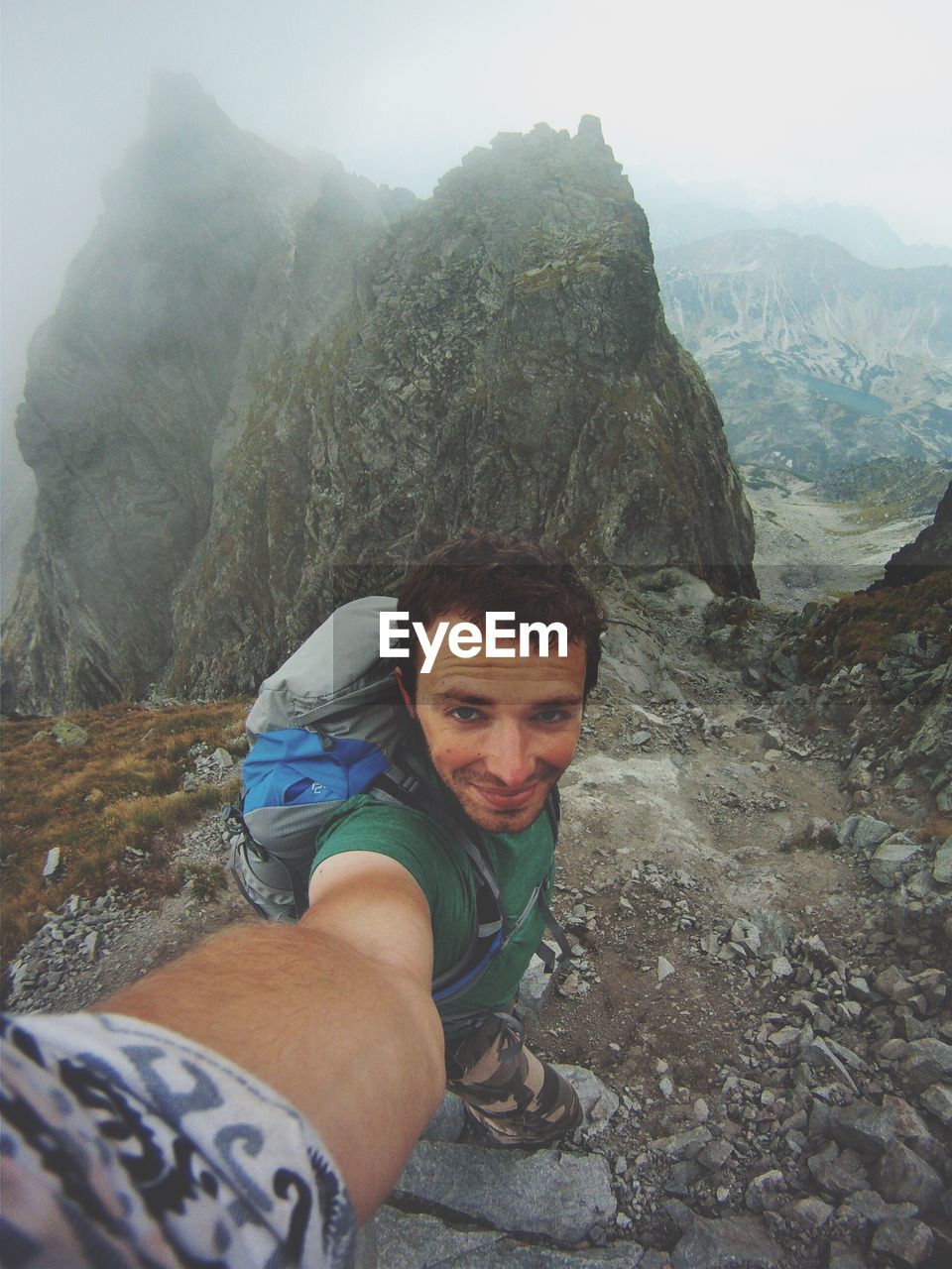 Portrait of man standing against mountains