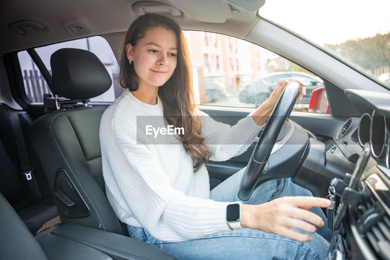 portrait of woman sitting in car in vehicle