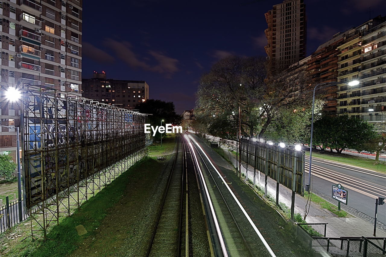 VIEW OF ILLUMINATED CITY AT NIGHT