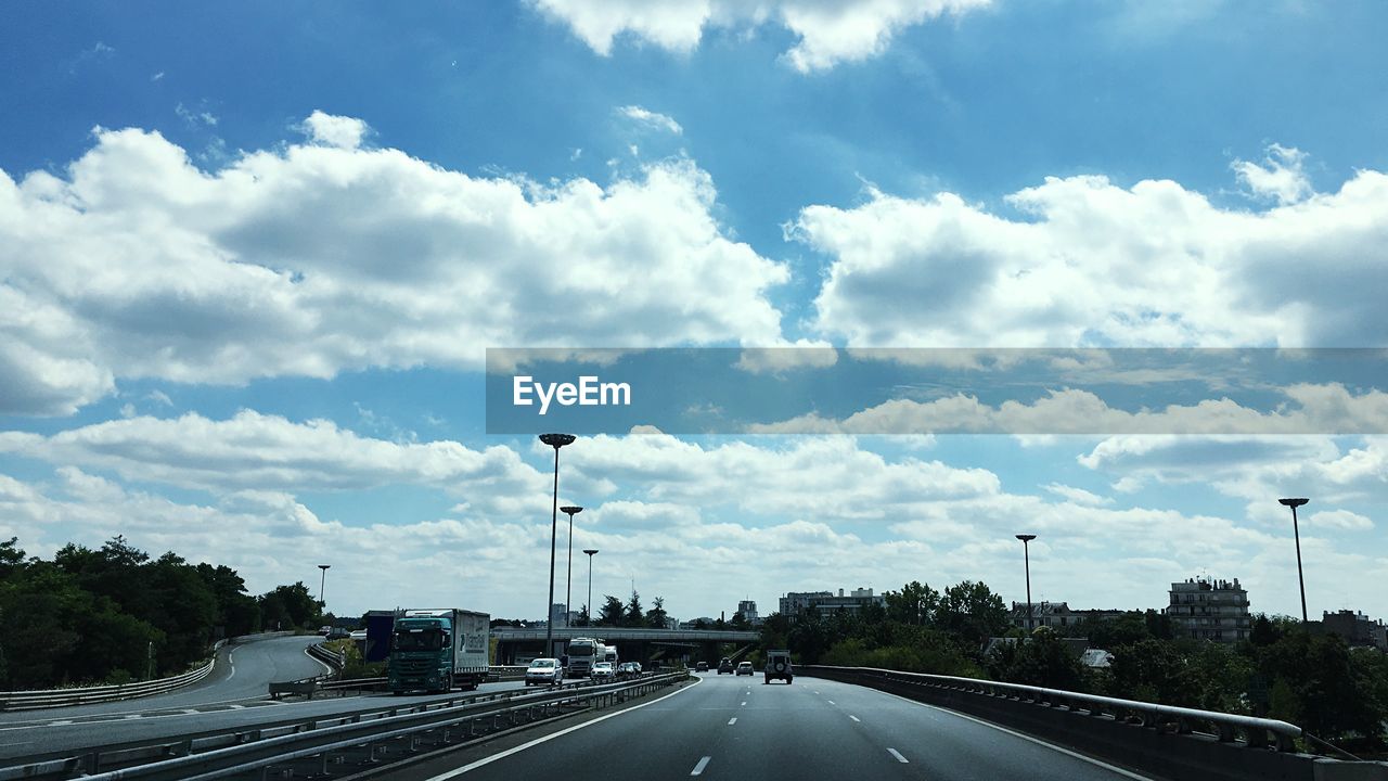 Highway against cloudy sky