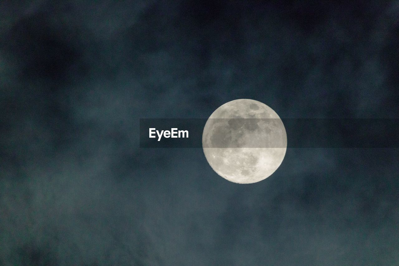 Low angle view of moon against sky at night