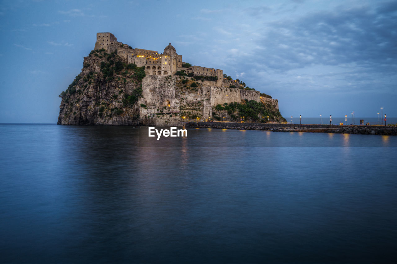 View of aragonese castle at blue hour, ischia, italy