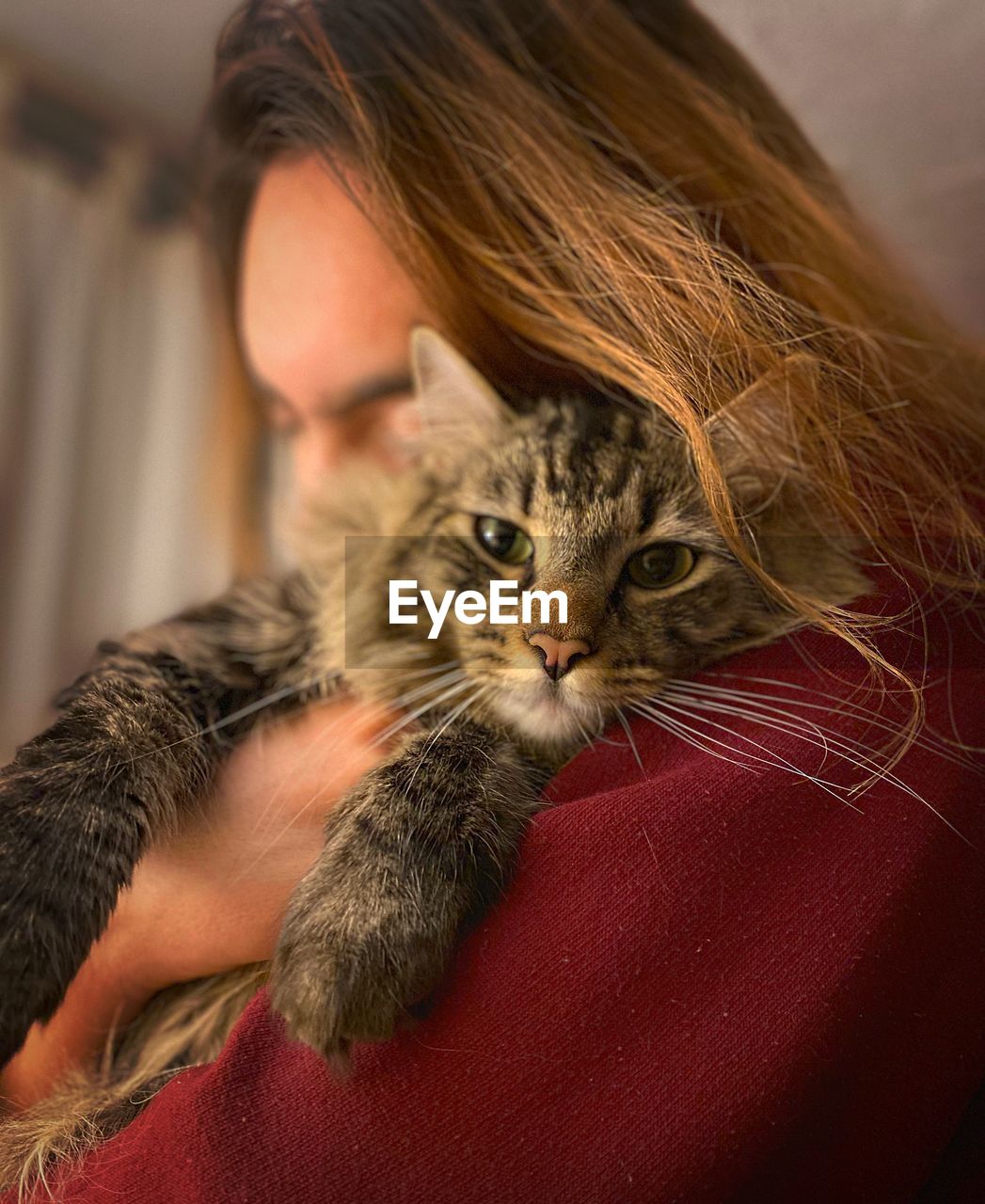 Young woman with cat at home