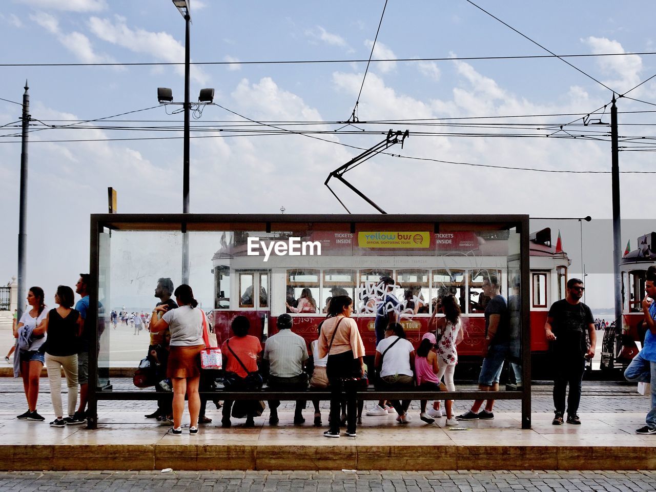 GROUP OF PEOPLE WAITING ON RAILWAY STATION